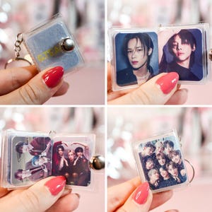 May include: Clear acrylic keychain with a small photo album design. The keychain features a silver metal clasp and a small, glittery blue cover. The album contains multiple photos of a group of people. The album is held open by a silver metal button.