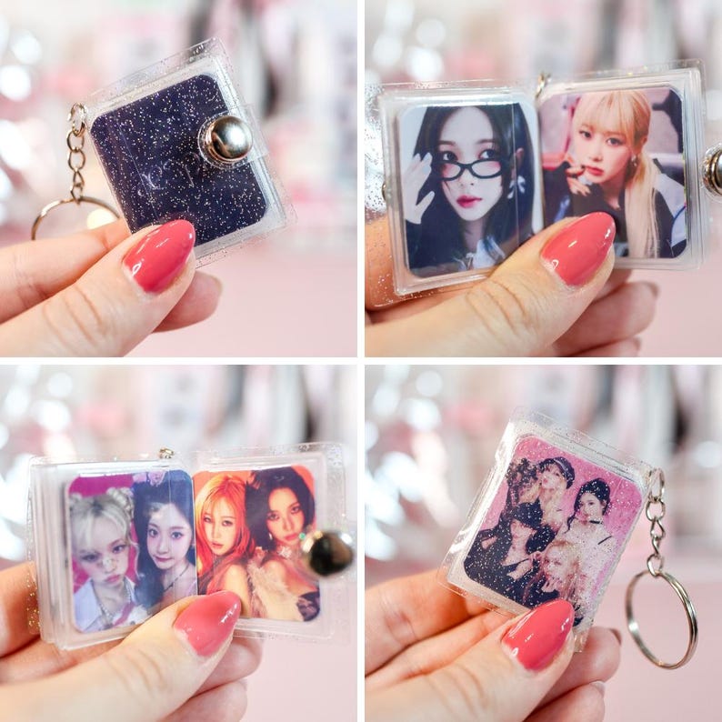 May include: Clear plastic keychain with a small, glittery, dark blue book-shaped charm. The keychain opens to reveal multiple photos of people. The keychain has a silver-colored metal ring.