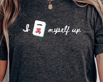May include: A dark heather gray short-sleeve t-shirt featuring the white text "I myself up" with a mahjong tile representing the character for ten thousand placed between the words "I" and "myself". The shirt has a crew neckline.