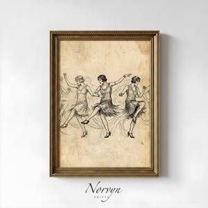 May include: A framed vintage print featuring a black and white illustration of flapper dancers in motion. The artwork has a sepia-toned background and is set in a gold-colored frame. The print is signed "Norvyn Prints" at the bottom.