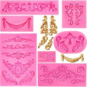 May include: A collection of pink silicone molds featuring various ornate, floral, and scrollwork designs. Several gold-colored decorative elements are also included, showcasing detailed baroque and rococo styles. Ideal for crafting and decorative projects.