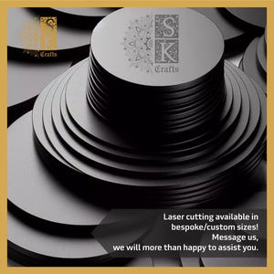 May include: A pile of dark grey, circular coasters with a laser-etched design and the text "SK Crafts." The coasters are arranged in a layered pattern. The image also includes the text: "Laser cutting available in bespoke/custom sizes!"