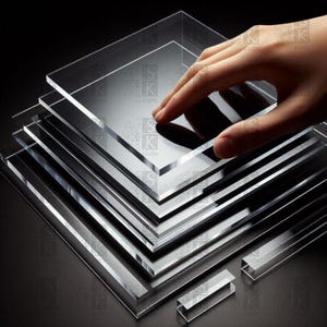 May include: A collection of clear acrylic sheets, with a hand gently touching the top sheet. The sheets are square and of varying sizes. Two small, clear acrylic pieces are at the bottom. The image is set against a black backdrop.