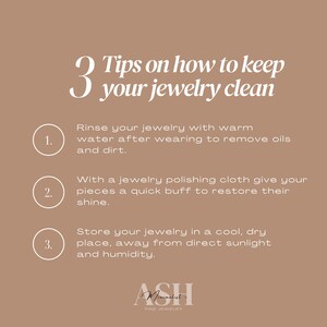 May include: A tan graphic with white text providing three tips on how to keep jewelry clean. The tips include rinsing with warm water, polishing with a cloth, and storing in a cool, dry place. The Ash Fine Jewelry logo is at the bottom.