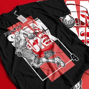 May include: Black t-shirt with a basketball player illustration in action, with the word "SLAM DUNK" in white over a red backdrop. Japanese text "スラムダンク" is also visible. The shirt has a tag that says "LARGE".