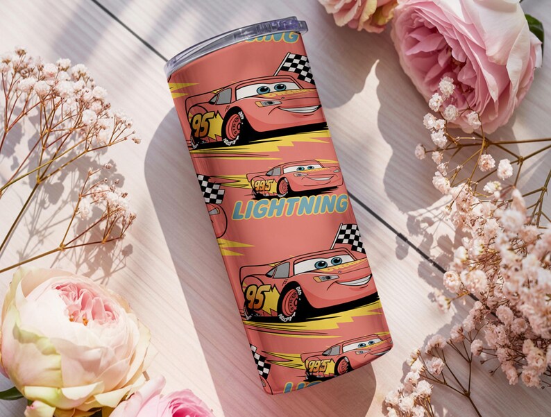 May include: A stainless steel tumbler featuring a repeating pattern of the animated character Lightning McQueen from the movie Cars. The design includes the number 95, a checkered flag, and the word "Lightning" on a coral background.