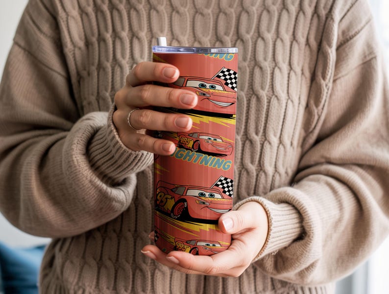 May include: A red tumbler featuring the character Lightning McQueen from the Cars movie. The design includes the number 95, checkered flags, and the word "Lightning". The tumbler has a silver lid and a white straw.
