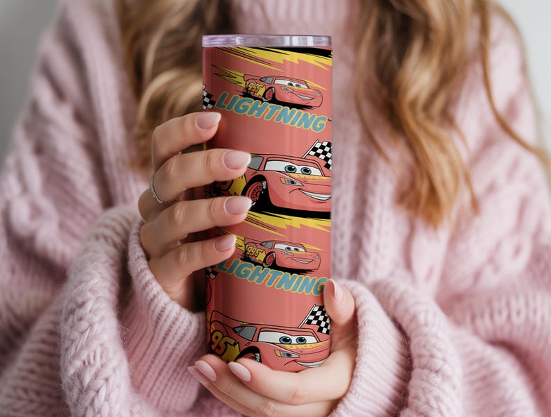 May include: A red tumbler featuring the character Lightning McQueen from the movie Cars. The tumbler has a repeating pattern of the character and the word "Lightning". The design includes a checkered flag and the number 95.
