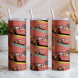 May include: Three red insulated tumblers with white straws. Each tumbler features a repeating pattern of Lightning McQueen from the Cars movie, the number 95, and the word "Lightning". The background is a reddish-orange color.