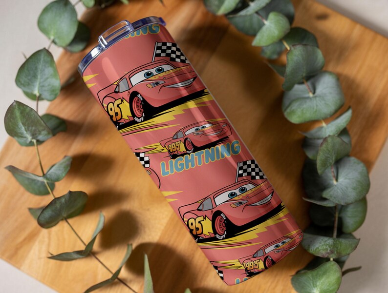 May include: A red tumbler featuring a repeating pattern of the character Lightning McQueen from the movie Cars. The design includes the number 95, checkered flags, and the word "Lightning". The tumbler has a silver lid.