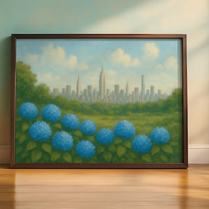May include: A framed landscape painting featuring a field of blue hydrangeas in the foreground, with a green meadow and a cityscape in the background. The sky is a light blue with fluffy white clouds. The frame is brown.