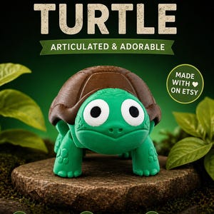 May include: A 3D-printed turtle figurine with a green body, brown shell, and large white-eyed face. The text "3D PRINTED TURTLE ARTICULATED & ADORABLE" is displayed above the turtle. The figurine is made with eco-friendly PLA and has an articulated design.