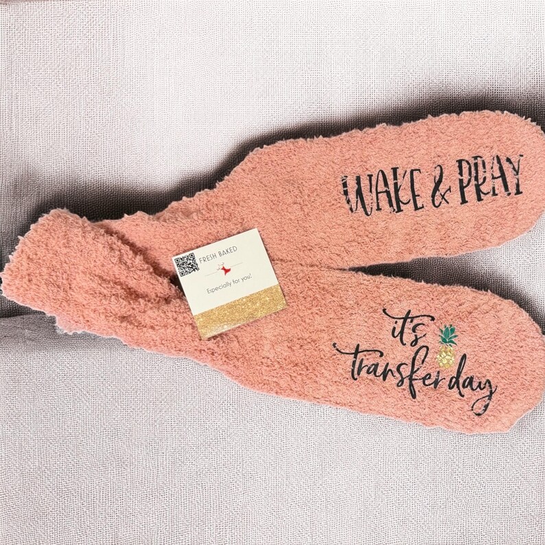 Set of personalized fuzzy pink socks with wake and pray it's transfer day printed on bottom, perfect for ivf transfer gift, iui gift or infertility gift for woman; multiple colors available