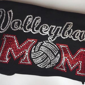 Sparkly Rhinestone Apparel Volleyball Mom Shirt Custom Crystal Design Team Colors Option Athletic Support Wear Personalized Glitter Details Game Day Fashion Statement Parent Gift Idea Special Occasion Clothing Unique Bling Creation Sports