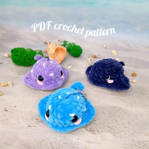 May include: A collection of handmade crochet stingrays in blue, purple, and navy blue. Each stingray has white spots, black eyes, and pink cheeks. The text "PDF crochet pattern" is visible in the image.