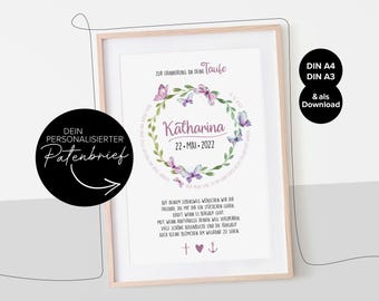 May include: Framed print with a floral wreath design and the name "Katharina" and date "22-MAI-2022". The print includes text in German, a cross, a heart, and an anchor. The frame is light-colored.