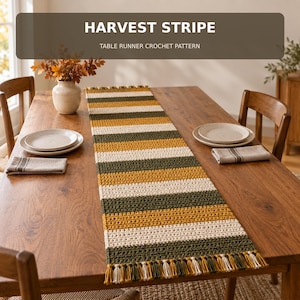May include: A rectangular crochet table runner featuring horizontal stripes in mustard yellow, olive green, and cream. The runner has a fringed edge on both ends. The text HARVEST STRIPE TABLE RUNNER CROCHET PATTERN is displayed at the top.