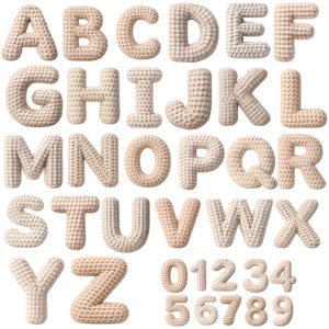 May include: A full alphabet and numbers set, each letter and number is a beige, textured, 3D design. The letters are in uppercase, and the numbers are from zero to nine. The letters and numbers are arranged in rows and columns against a white background.
