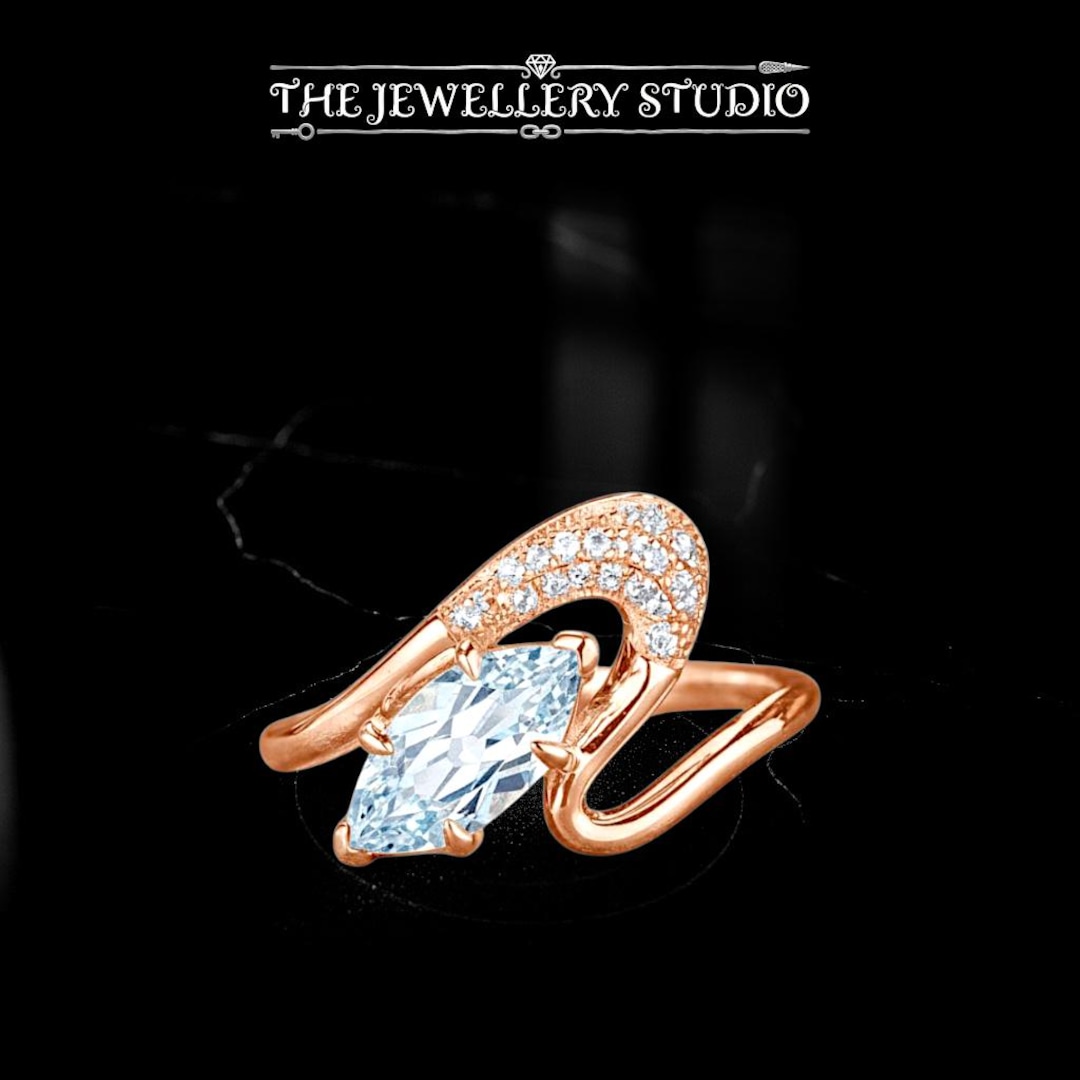 marquise-cut-aquamarine-ring-rose-gold-swirl-ring-modern-engagement