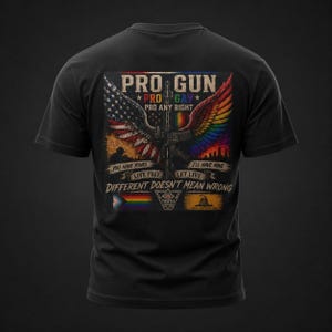 Peut inclure: Un t-shirt noir avec un motif au dos représentant un fusil central entouré d'ailes, l'une aux couleurs du drapeau américain et l'autre avec un dégradé arc-en-ciel. Le texte inclut PRO GUN, PRO GAY, PRO ANY RIGHT et DIFFERENT DOESN'T MEAN WRONG.