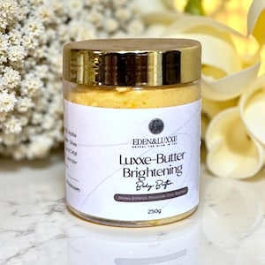 May include: A jar of Luxxe-Butter Brightening Body Butter with a gold lid and a white label. The label includes the brand name, product name, and a list of ingredients. The jar contains 250g of body butter.