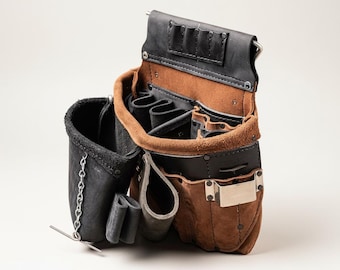 May include: A leather tool belt with multiple pockets and compartments. The belt features a combination of black and brown leather, with a metal clip and rivets. The open design reveals various slots for tools, and a small chain detail.