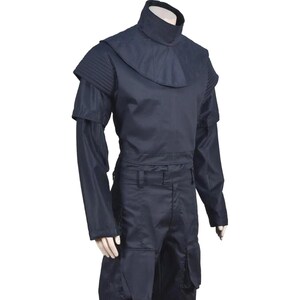 May include: A dark navy blue uniform set consisting of a high-neck top with a structured shoulder yoke and long sleeves, paired with matching trousers featuring large, prominent cargo-style pockets on the thighs, displayed on a mannequin.