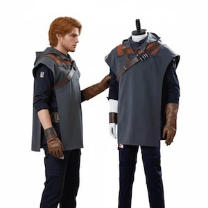 May include: A grey hooded tunic with brown leather detailing, worn over a dark blue shirt and trousers. The costume includes brown gloves and boots. A mannequin displays the outfit, alongside a person wearing the same costume.
