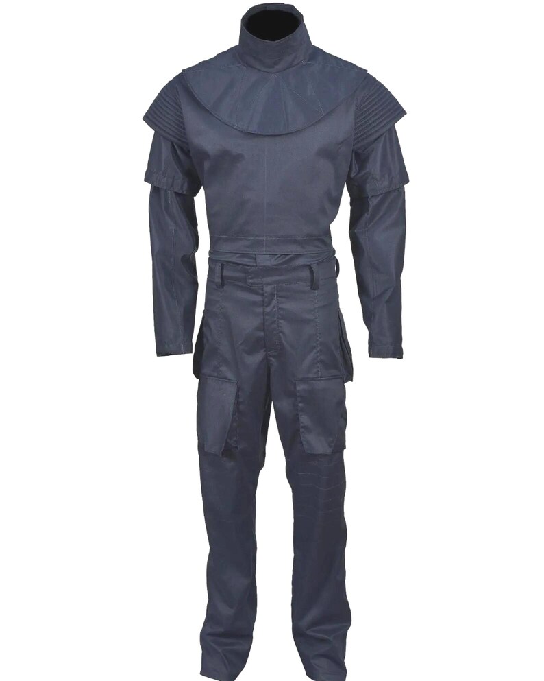 May include: A dark navy blue uniform set consisting of a long-sleeved top and matching trousers. The top features a high collar, a wide rounded shoulder yoke, and ribbed detailing on the upper sleeves. The trousers include large cargo pockets.