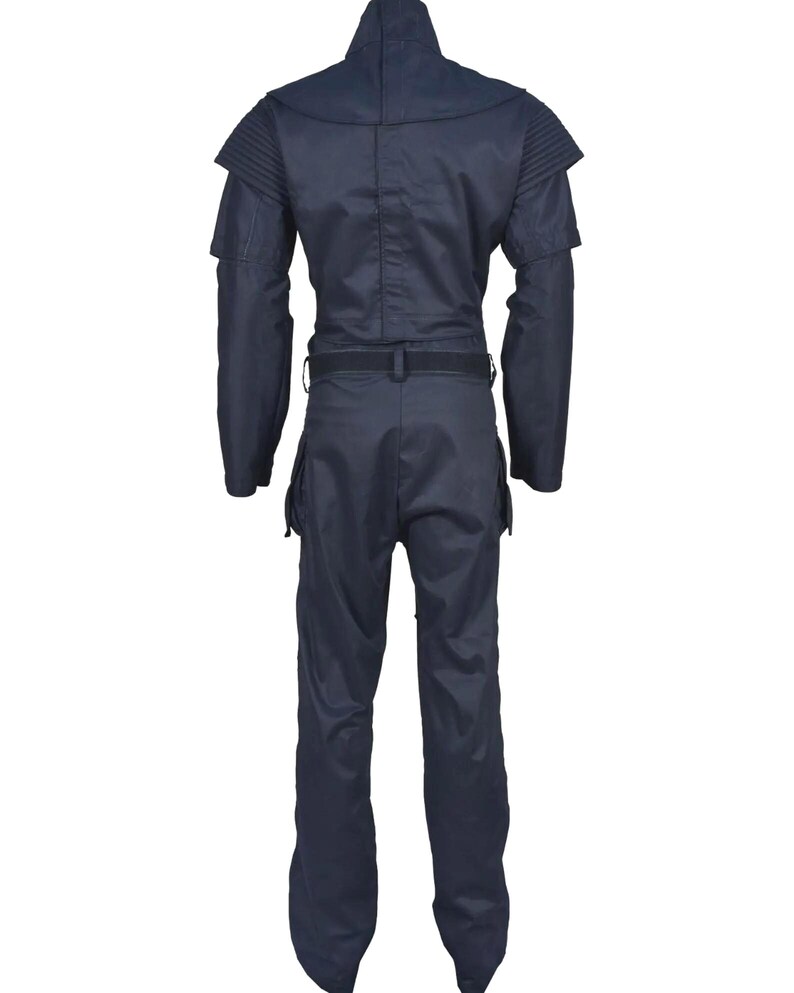 May include: A dark navy blue jumpsuit featuring a high collar, structured shoulder panels with ribbed detailing, long sleeves, and a waist belt. The garment includes cargo-style pockets on the thighs and a straight-leg cut, presented from the back view.