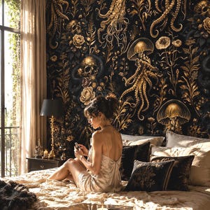 May include: Wallpaper featuring a dark black background with gold illustrations of jellyfish, skulls, and floral patterns. The design includes intricate tentacles and botanical elements, creating a detailed, high-contrast wall covering.