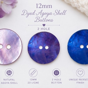May include: Three round 12mm dyed Agoya shell buttons with two holes each, featuring iridescent finishes in shades of light purple, deep violet, and royal blue. The text 12mm Dyed Agoya Shell Buttons 2 HOLE is printed above the buttons.