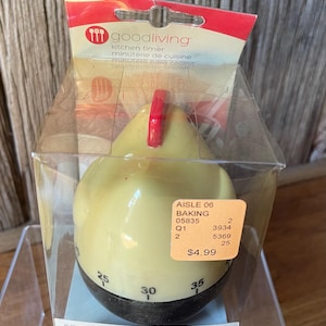 May include: A yellow and black chicken-shaped kitchen timer in a clear plastic box. The timer features a red comb on top and black numbers ranging from 25 to 35 visible on the base. The packaging includes the text goodliving kitchen timer.