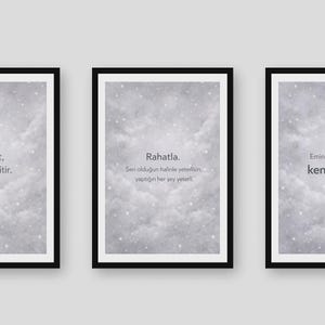 May include: Three framed art prints with black frames. Each print features a cloudy, gray background with white text. The text on the first print reads, "Şefkat, öfkeyi eritir." The second print reads, "Rahatla. Sen olduğun haline yetersin, yaptığın her şey yeter." The third print reads, "Emin olmadığında, kendini seç."