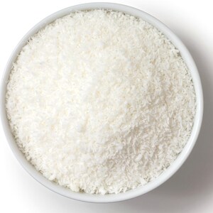 Overhead image of a bowl of Shredded coconut on white background.