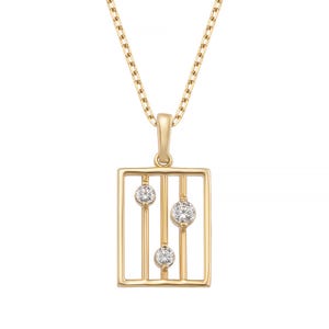 May include: A gold-colored pendant necklace featuring a rectangular frame design with three clear, round gemstones. The pendant hangs from a delicate gold chain. The gemstones are set along vertical bars within the frame, creating a modern, geometric aesthetic.