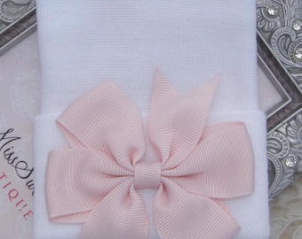 White newborn hospital hat with light mauve pinwheel ribbon pearl bow, baby hat, perfect baby shower gift, from Lil Miss Sweet Pea Boutique