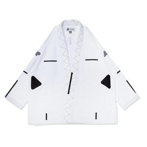 May include: White martial arts gi with black accents. The gi features black triangle shapes, horizontal lines, and zigzag stitching. Logos are visible on the sleeves and chest. The gi is designed for martial arts training and competition.