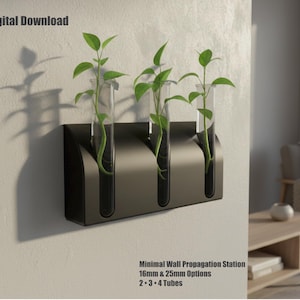 May include: A minimalist black wall propagation station with three clear glass tubes, each holding a green plant. The station is mounted on a light-colored wall. Text on the image reads "STL Digital Download" and "Minimal Wall Propagation Station".