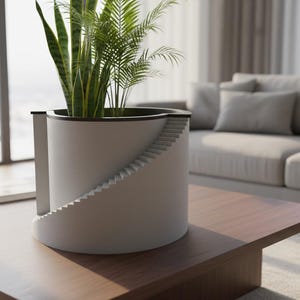May include: A modern, white cylindrical planter with a unique staircase design on its side. The planter holds a variety of green plants. It sits on a wooden coffee table in a well-lit living room.