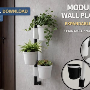 May include: A modular wall planter with three white pots holding various plants. The planter has a black and white frame and is mounted on a grey wall. Text on the image reads "DIGITAL DOWNLOAD STL FILE" and "MODULAR WALL PLANTER EXPANDABLE DESIGN PRINTABLE NO SUPPORTS."
