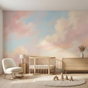 May include: A nursery room featuring a wall mural of a soft, painterly sky with pastel pink and blue clouds. The room includes a light wood oval crib, a cream-colored rocking chair, a wooden side table with a lamp, and a round white rug.