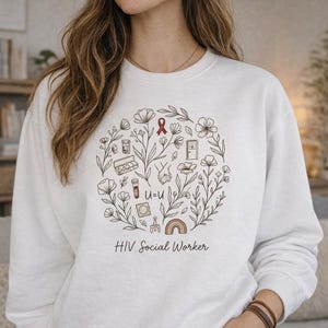May include: A white crewneck sweatshirt featuring a circular graphic of line-art flowers and symbols including a red ribbon, a pill bottle, a pill organizer, a vial, a condom, a rainbow, and the text U=U, with the words HIV Social Worker below.