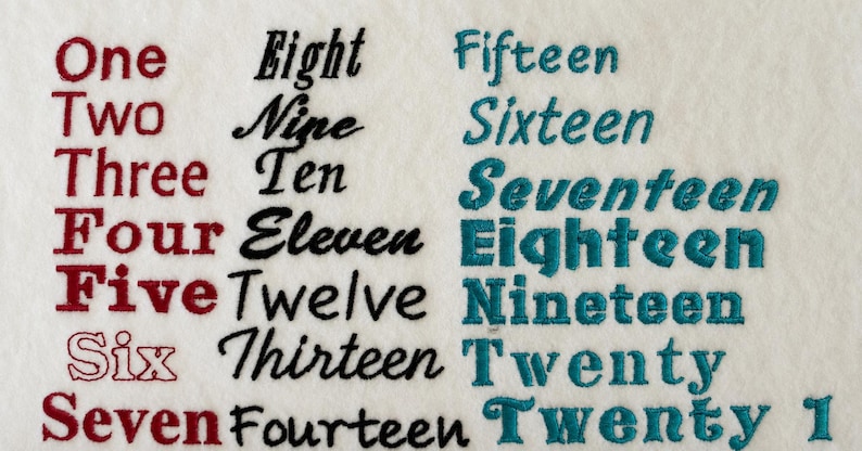 May include: An embroidery sample on white fabric featuring the words One through Seven in red, Eight through Fourteen in black, and Fifteen through Twenty 1 in teal. Each word is stitched in a different font style, showcasing various lettering designs.