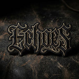 May include: A black embroidered patch with the word "Echoes" in an ornate, gothic font. The lettering is outlined in gold thread, creating a striking contrast against the black fabric. The patch is likely for clothing or accessories.