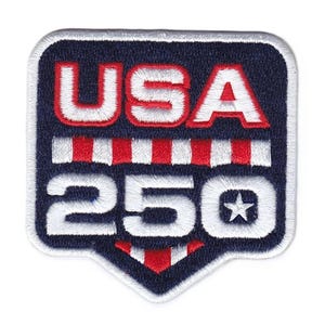 May include: Embroidered patch with a navy blue background and white border. The patch features the word "USA" in white, outlined in red, above the number "250" in white. A small white star is on the right side of the number.