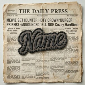 May include: A black and gray embroidered patch with the word "Name" in a cursive font, set against a vintage newspaper background. The newspaper is dated March 12, 1956, with headlines visible.