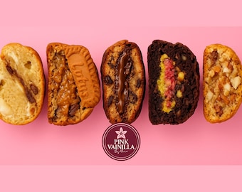 May include: An overhead shot of five different halves of baked goods, each with a unique filling. The baked goods are arranged on a pink background. The logo for Pink Vainilla is at the bottom. The baked goods include cookies and cakes.