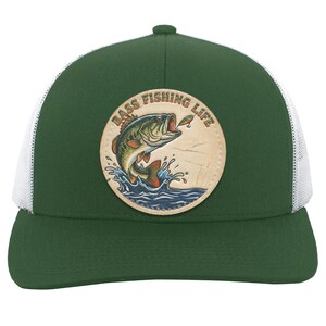 May include: A forest green baseball cap with white mesh back panels and a circular leather patch on the front. The patch features a colorful illustration of a bass fish jumping out of blue water with the text BASS FISHING LIFE arched above.