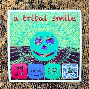 May include: A square sticker with the text "a tribal smile" in red. The sticker features a smiling face with purple eyes and a teal background. Below are icons for music apps, including a pink music note, an Amazon Music logo, a Spotify logo, and a QR code.